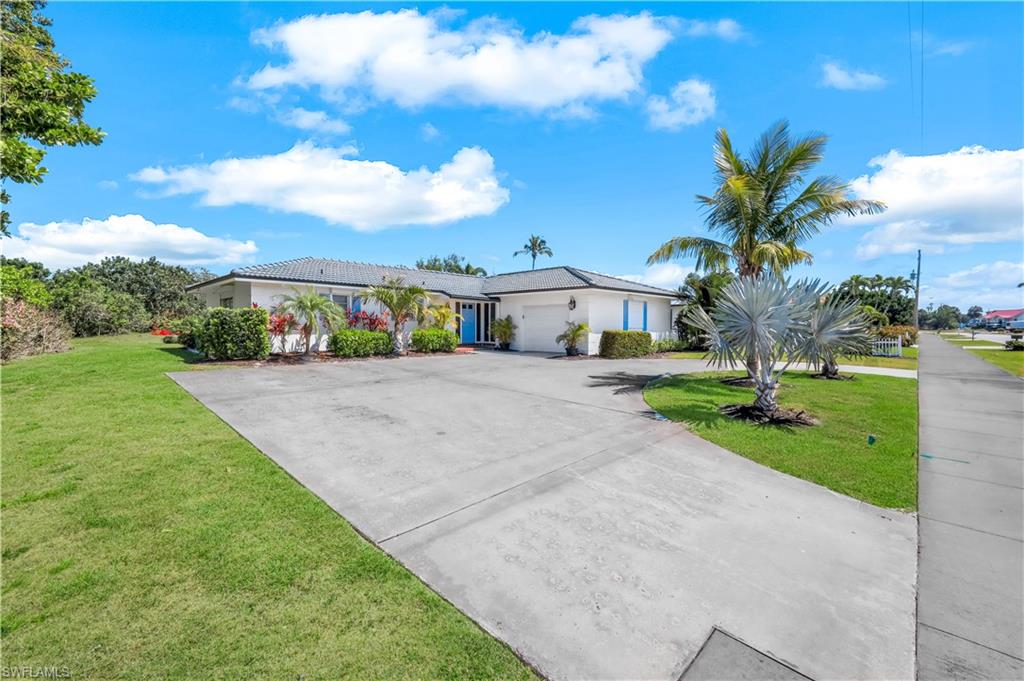 1382 Jamaica Road Marco Island, FL 34145 - Photo 2 of 27 a view of a house with a yard