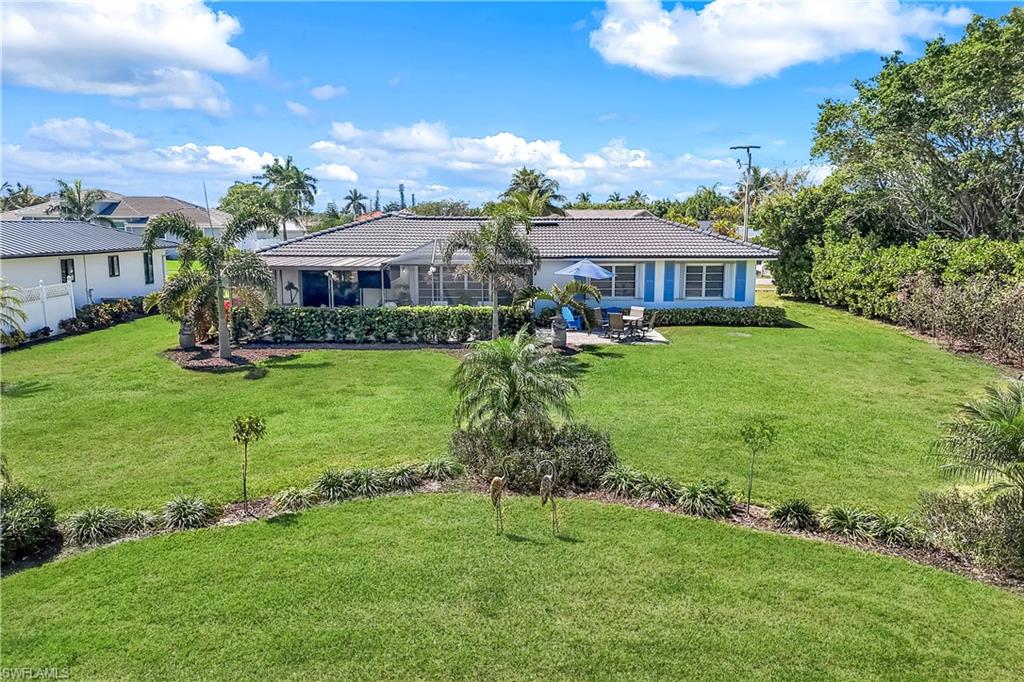 1382 Jamaica Road Marco Island, FL 34145 - Photo 24 of 27 a front view of a house with a garden