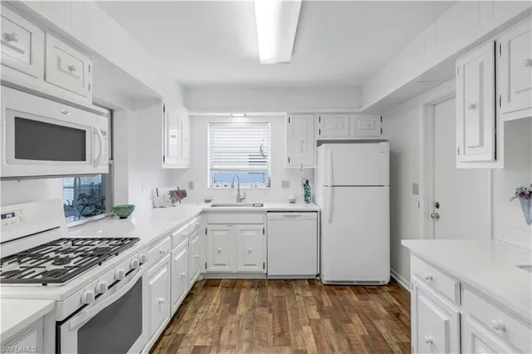 a kitchen with a sink stove and refrigerator