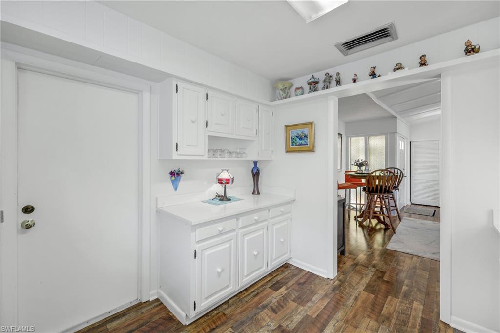 1382 Jamaica Road Marco Island, FL 34145 - Photo 7 of 27 a view of utility room and bedroom with wooden floor