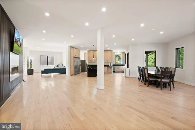 a kitchen with stainless steel appliances granite countertop a refrigerator a stove and a wooden floors