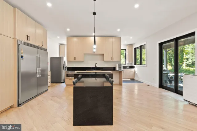 a kitchen with stainless steel appliances granite countertop a stove and a refrigerator