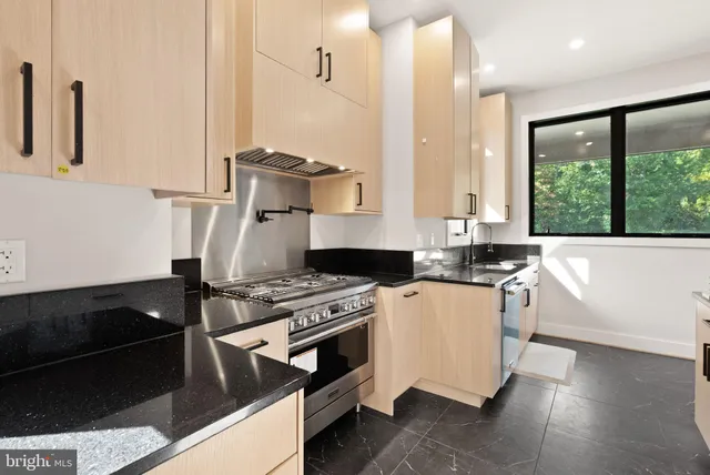 a kitchen with stainless steel appliances granite countertop a sink and a cabinets