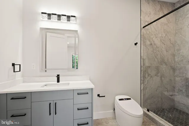 a spacious bedroom with a large bed and a flat tv screen on dresser