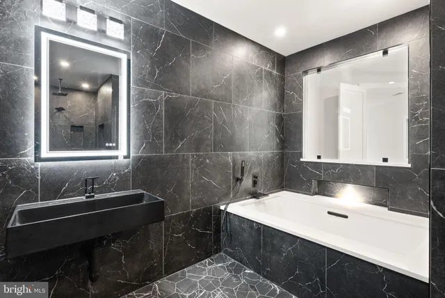 a living room with furniture and a computer on a desk