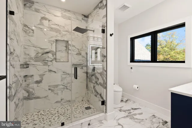 an aerial view of a house with swimming pool and yard