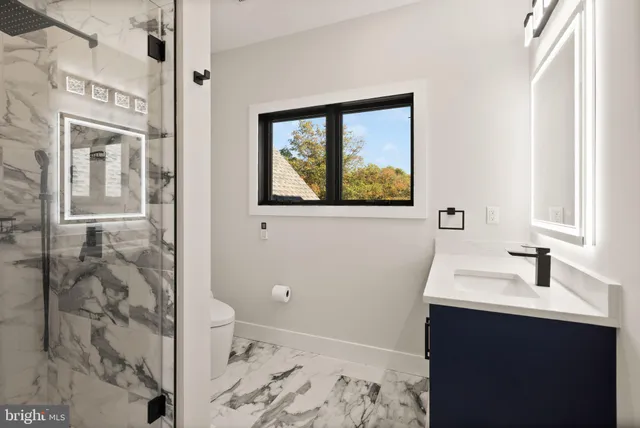 an aerial view of a house with a yard basket ball court and outdoor seating