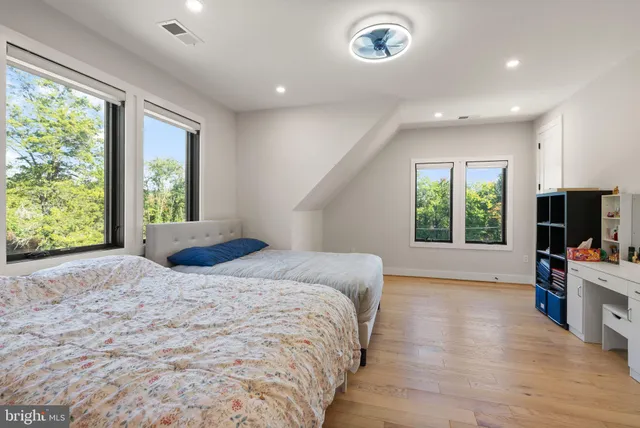 an aerial view of a residential houses with outdoor space and trees