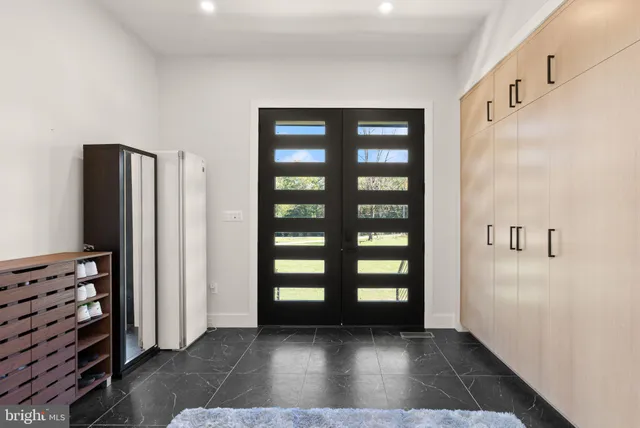 a view of a hallway with wooden floor and stairs