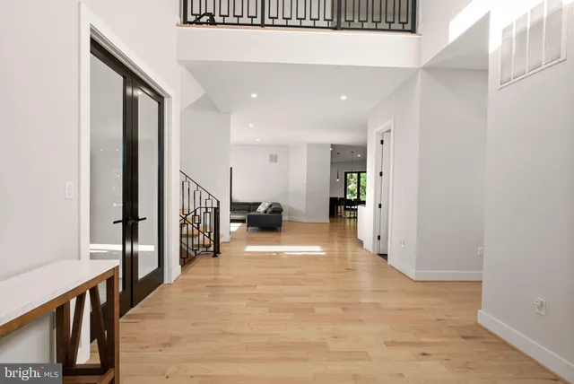 a living room with furniture and a open kitchen view