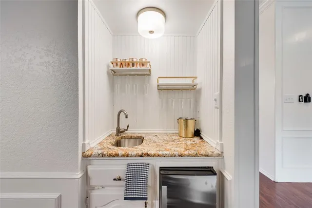 a kitchen with a granite countertop sink and stove