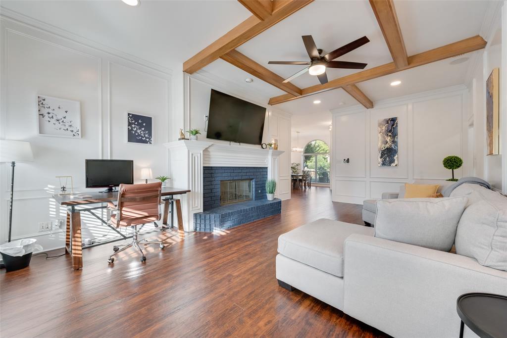 4027 Red Maple Drive Carrollton, TX 75007 - Photo 12 of 35 a living room with furniture a fireplace and a flat screen tv