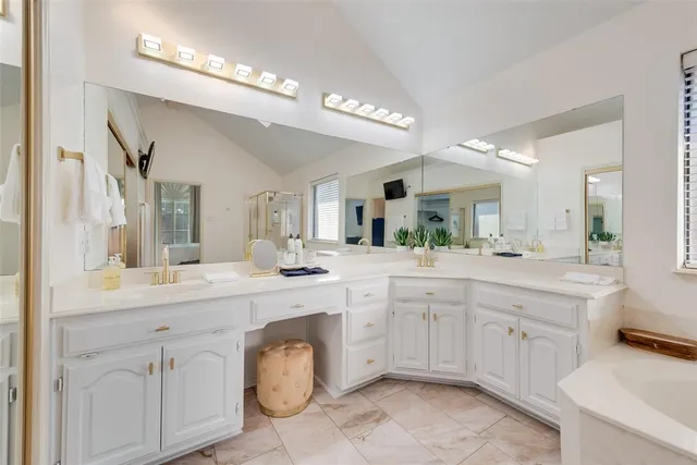 a spacious bathroom with a granite countertop double sink and a mirror