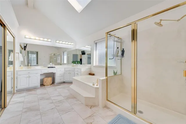 a bathroom with a tub shower and sink