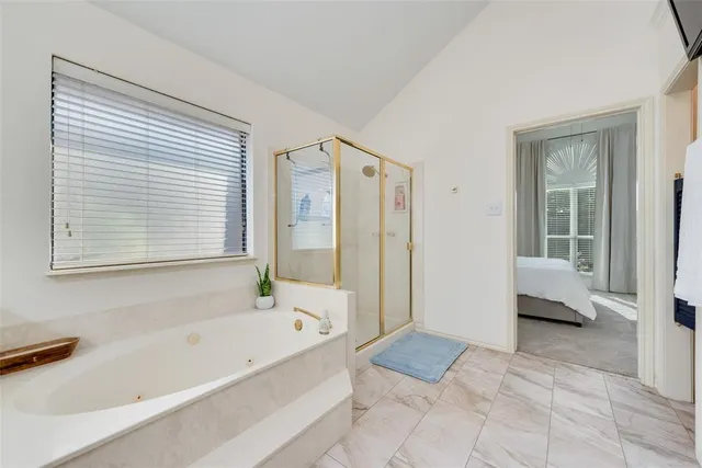 a bathroom with a bathtub and a shower