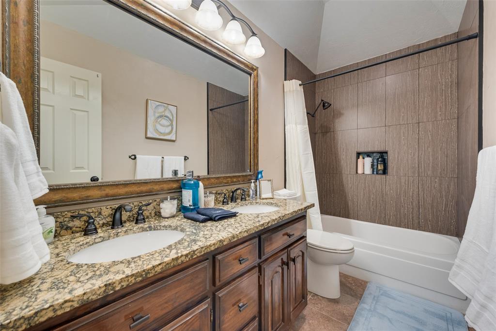 4027 Red Maple Drive Carrollton, TX 75007 - Photo 21 of 35 a bathroom with a granite countertop sink and a mirror