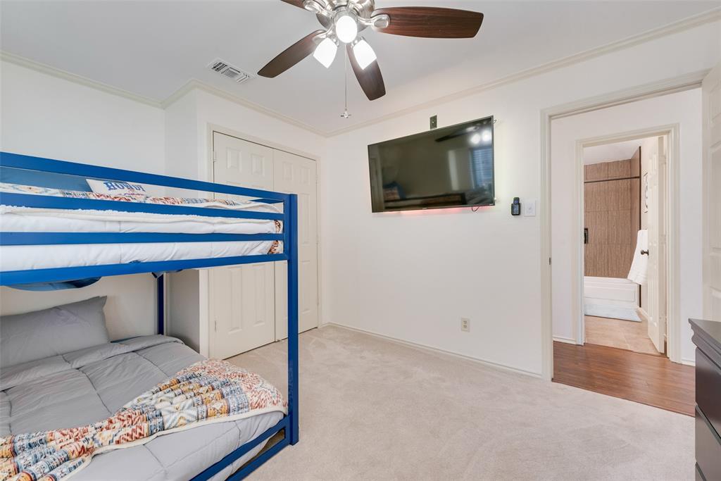4027 Red Maple Drive Carrollton, TX 75007 - Photo 23 of 35 a bedroom with a bed and a flat screen tv