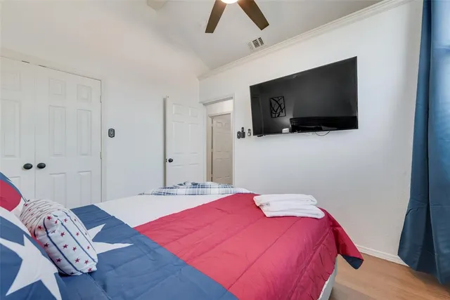 a bedroom with a bed and a flat screen tv