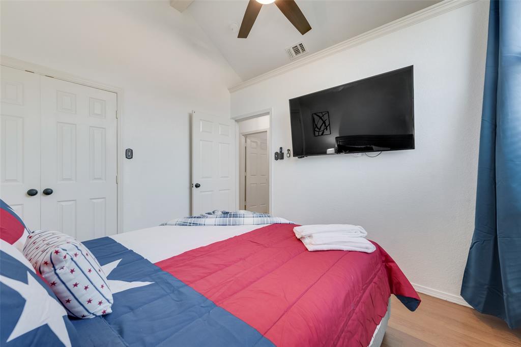 4027 Red Maple Drive Carrollton, TX 75007 - Photo 24 of 35 a bedroom with a bed and a flat screen tv