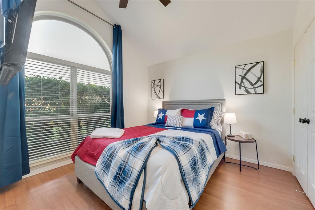 4027 Red Maple Drive Carrollton, TX 75007 - Photo 25 of 35 a bedroom with a bed and a large window