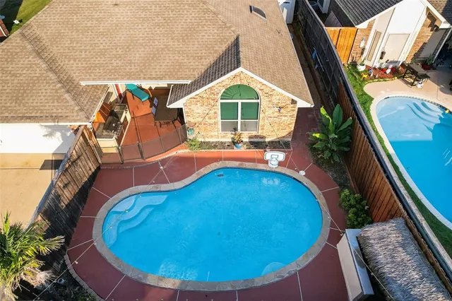 a view of a swimming pool with a patio