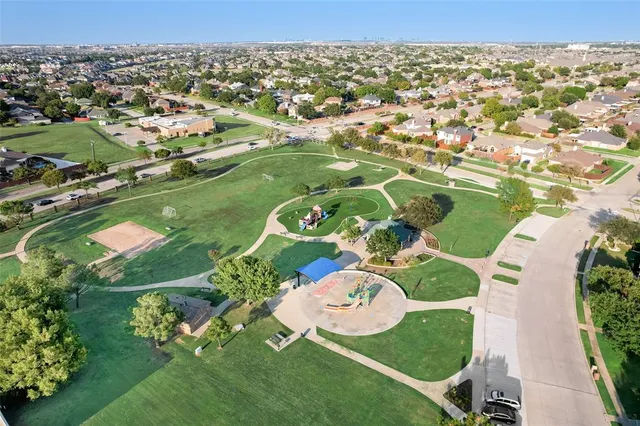 an aerial view of a residential houses with outdoor space and street view