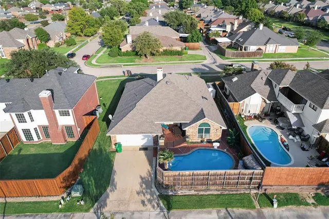 an aerial view of a house with a yard basket ball court and outdoor seating