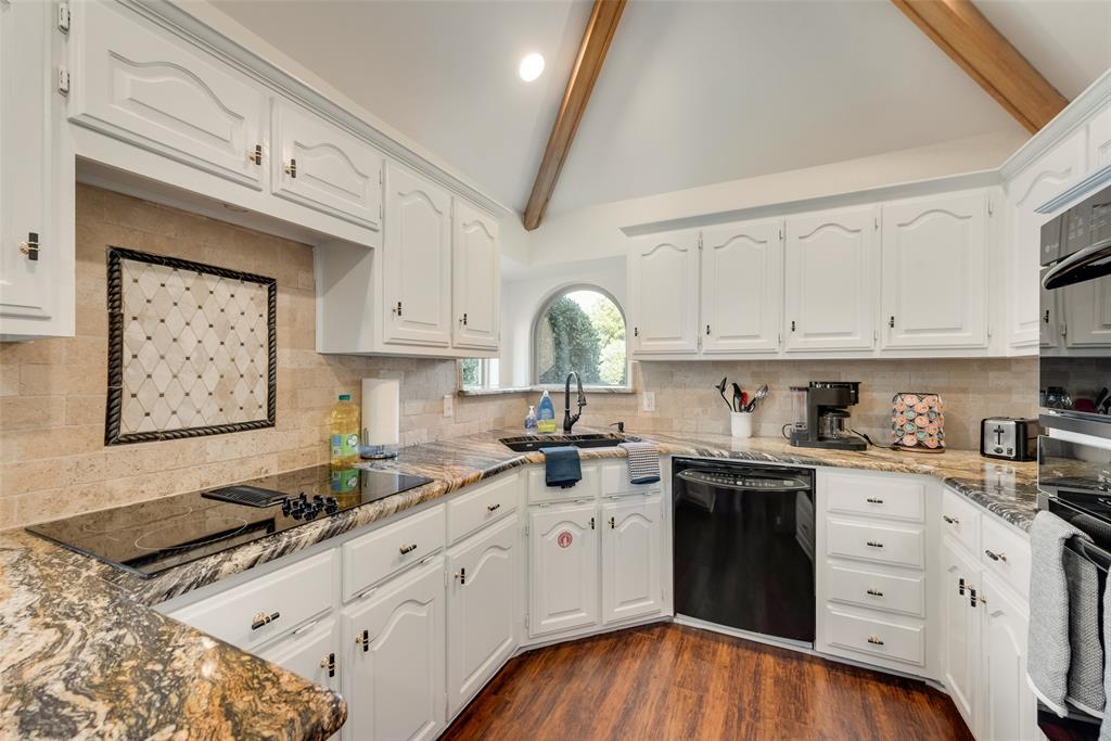 4027 Red Maple Drive Carrollton, TX 75007 - Photo 4 of 35 a kitchen with granite countertop a sink stainless steel appliances and cabinets