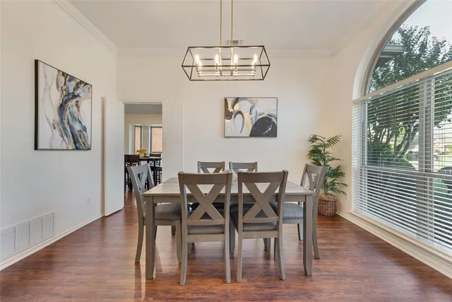 a view of a dining room with furniture wooden floor and a chandelier