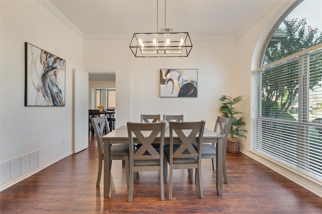 4027 Red Maple Drive Carrollton, TX 75007 - Photo 6 of 35 a view of a dining room with furniture wooden floor and a chandelier