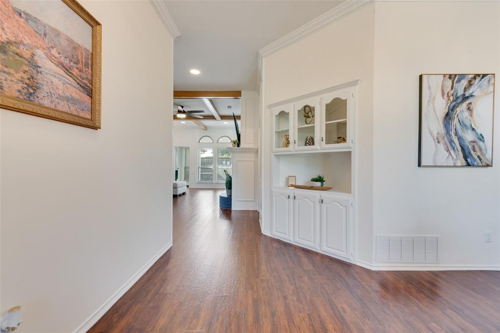 4027 Red Maple Drive Carrollton, TX 75007 - Photo 10 of 35 a view of a hallway with wooden floor and a cabinet