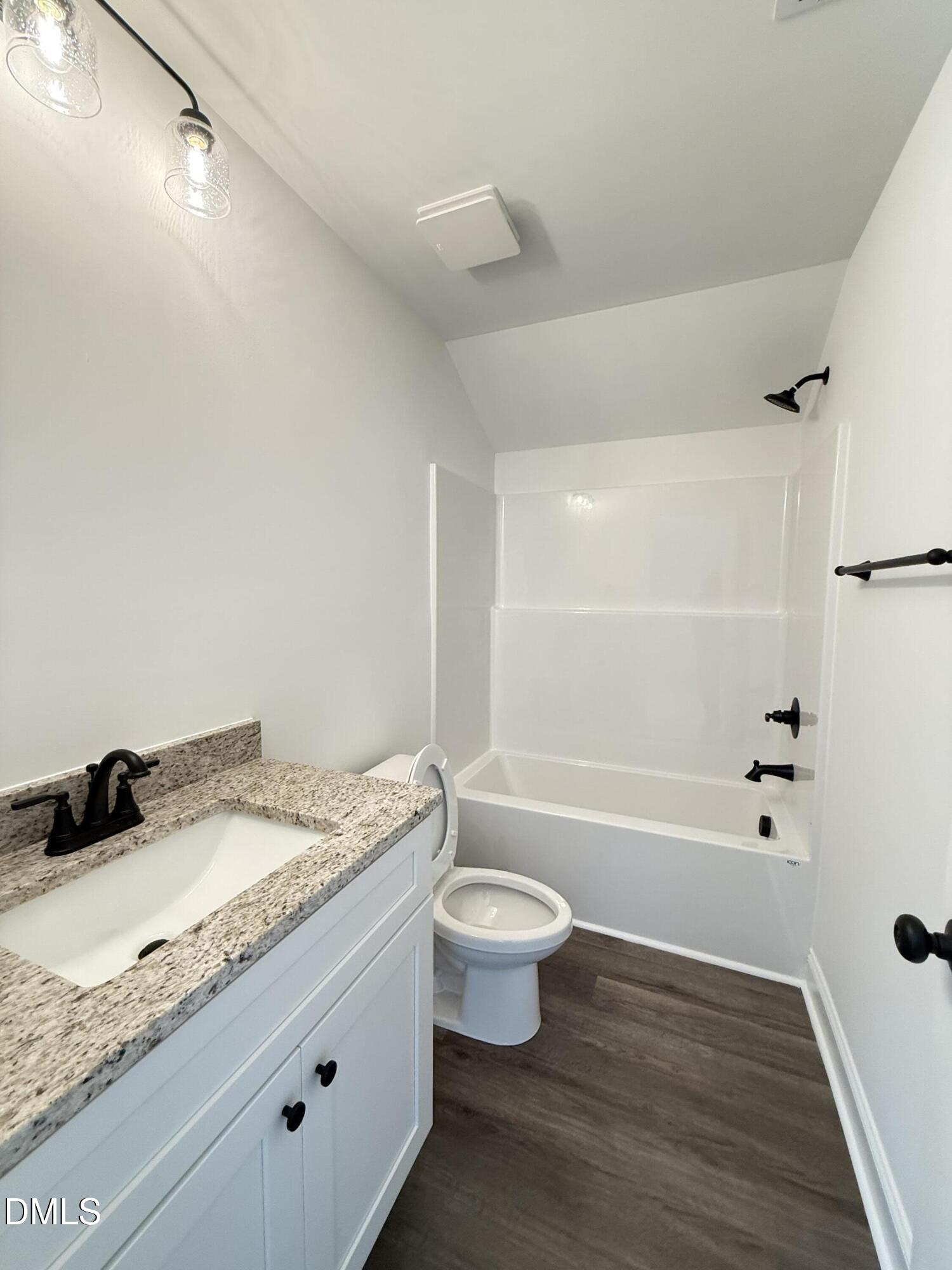 10300 Stallings Road Spring Hope, NC 27882 - Photo 32 of 36 a bathroom with a granite countertop sink a toilet and bathtub