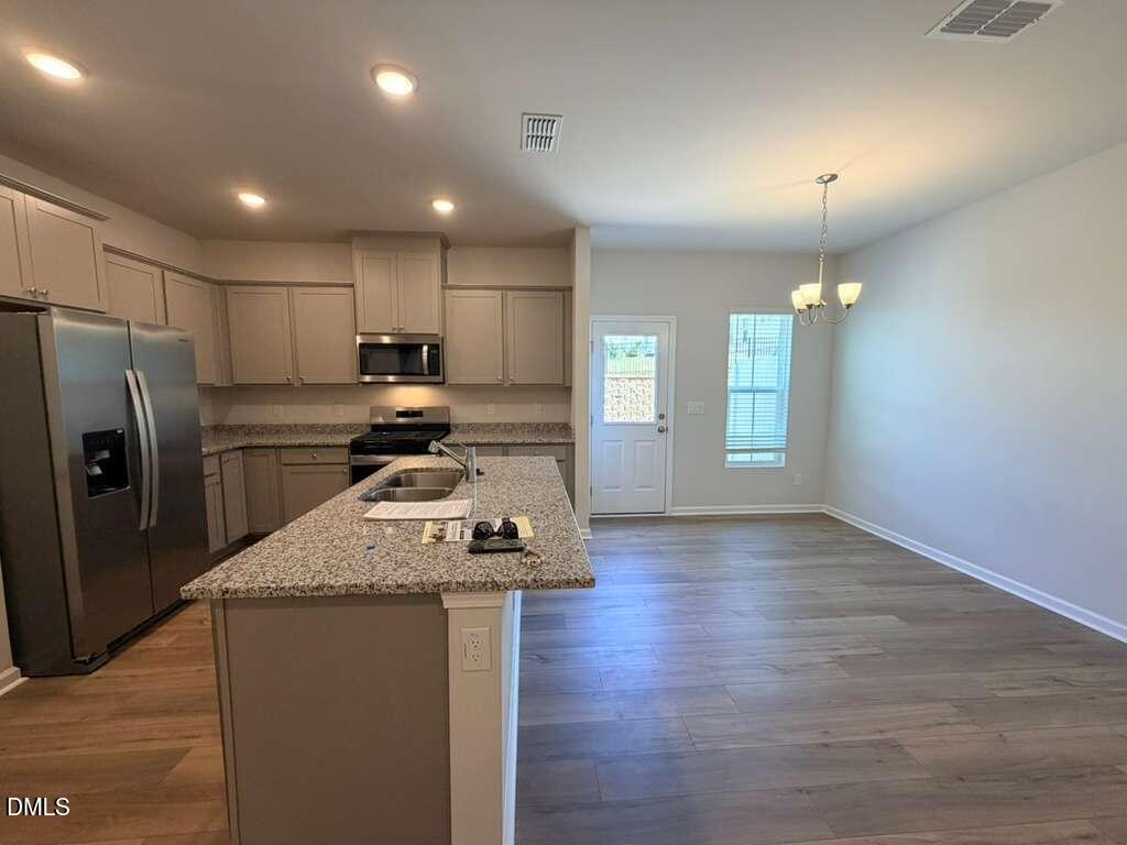 5024 Reader Way Durham, NC 27703 - Photo 6 of 26 a kitchen with stainless steel appliances granite countertop a refrigerator a sink dishwasher a stove and a refrigerator