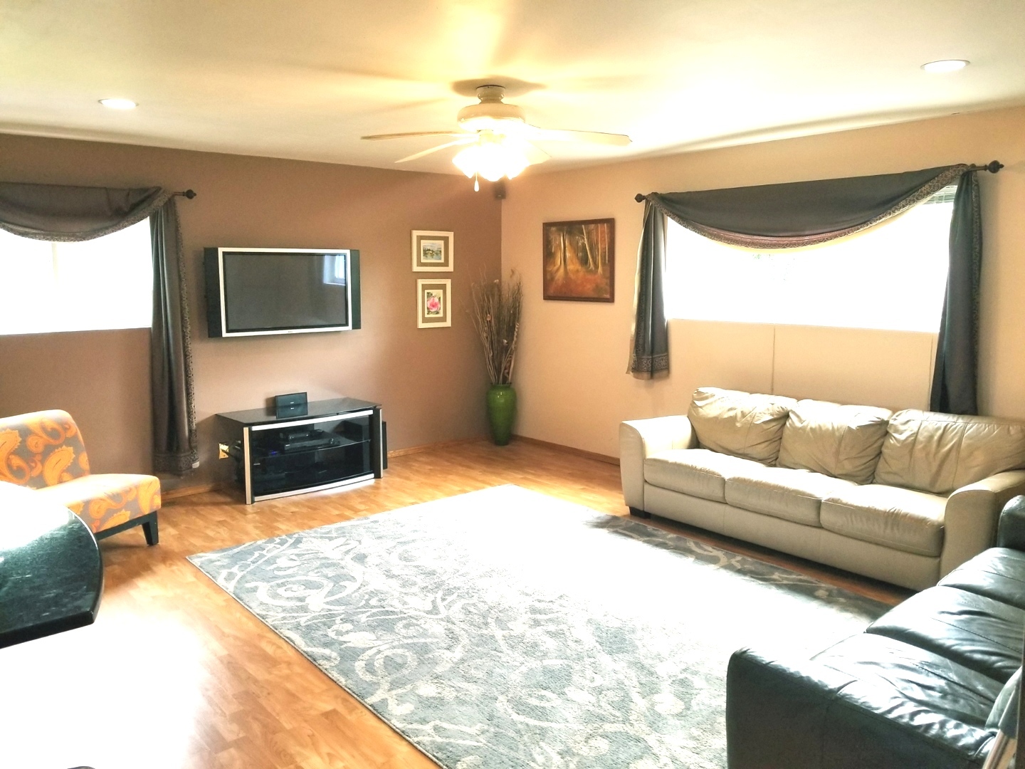 137 South Pinecrest Road Bolingbrook, IL 60440 - Photo 4 of 25 a living room with furniture and a flat screen tv