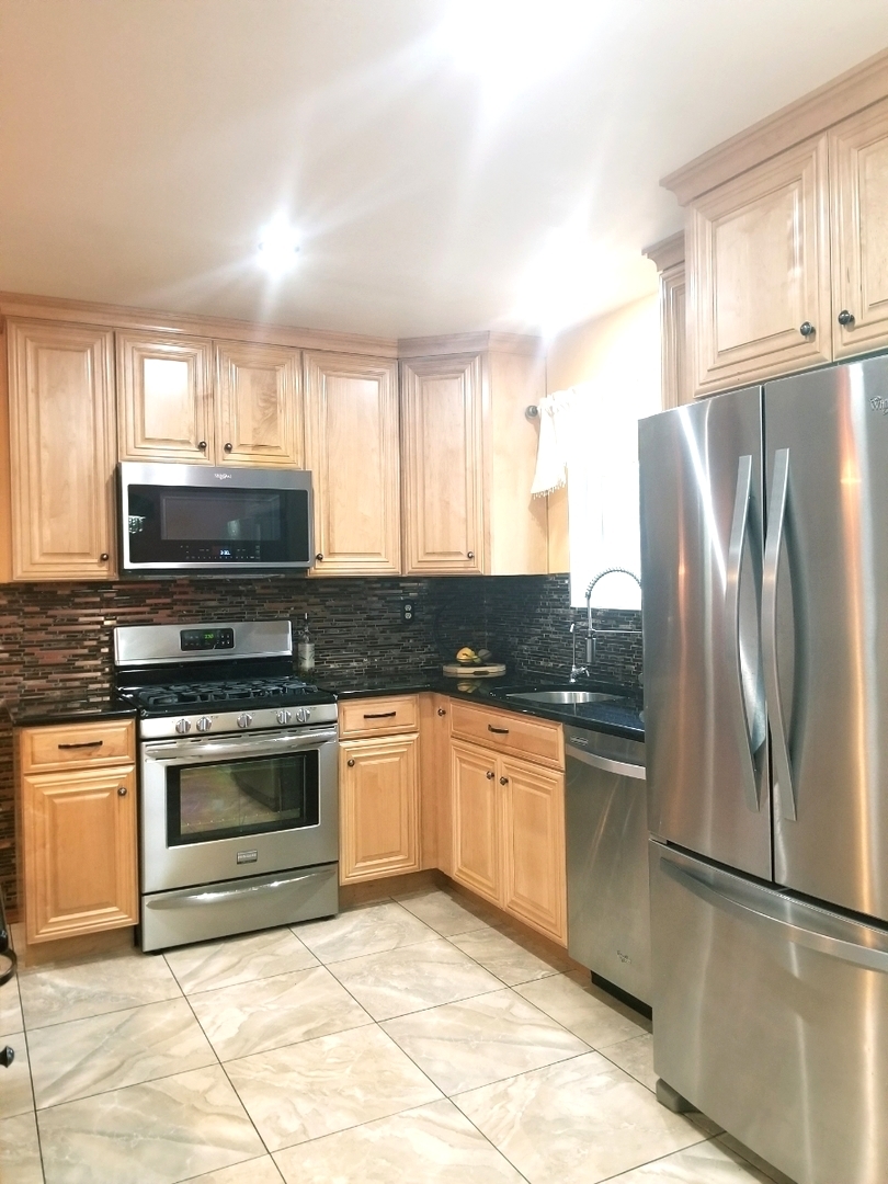 137 South Pinecrest Road Bolingbrook, IL 60440 - Photo 6 of 25 a kitchen with granite countertop a refrigerator and a sink