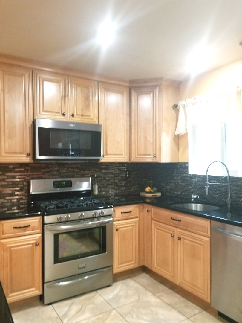 137 South Pinecrest Road Bolingbrook, IL 60440 - Photo 7 of 25 a kitchen with granite countertop white cabinets white stainless steel appliances and sink