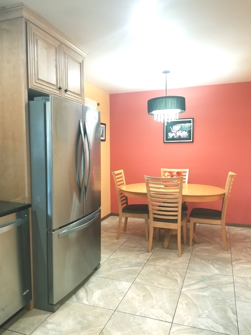 137 South Pinecrest Road Bolingbrook, IL 60440 - Photo 9 of 25 a kitchen with stainless steel appliances granite countertop a refrigerator and a sink