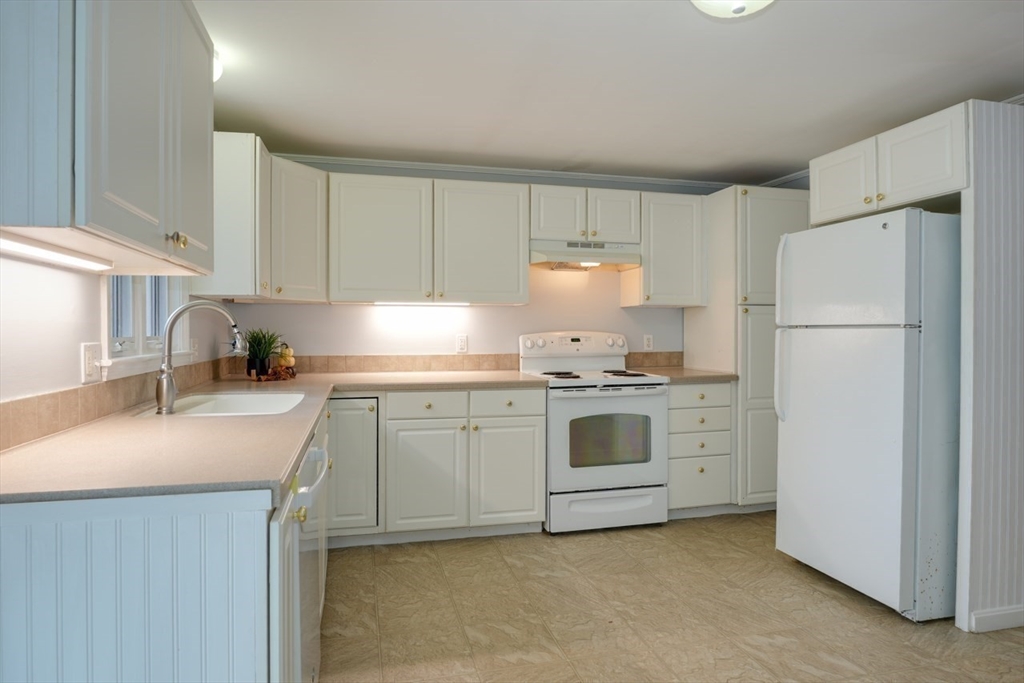 22 Granite Street Medway, MA 02053 - Photo 12 of 30 a kitchen with a white stove refrigerator and cabinets