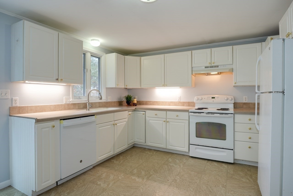 22 Granite Street Medway, MA 02053 - Photo 14 of 30 a kitchen with granite countertop white cabinets and white appliances