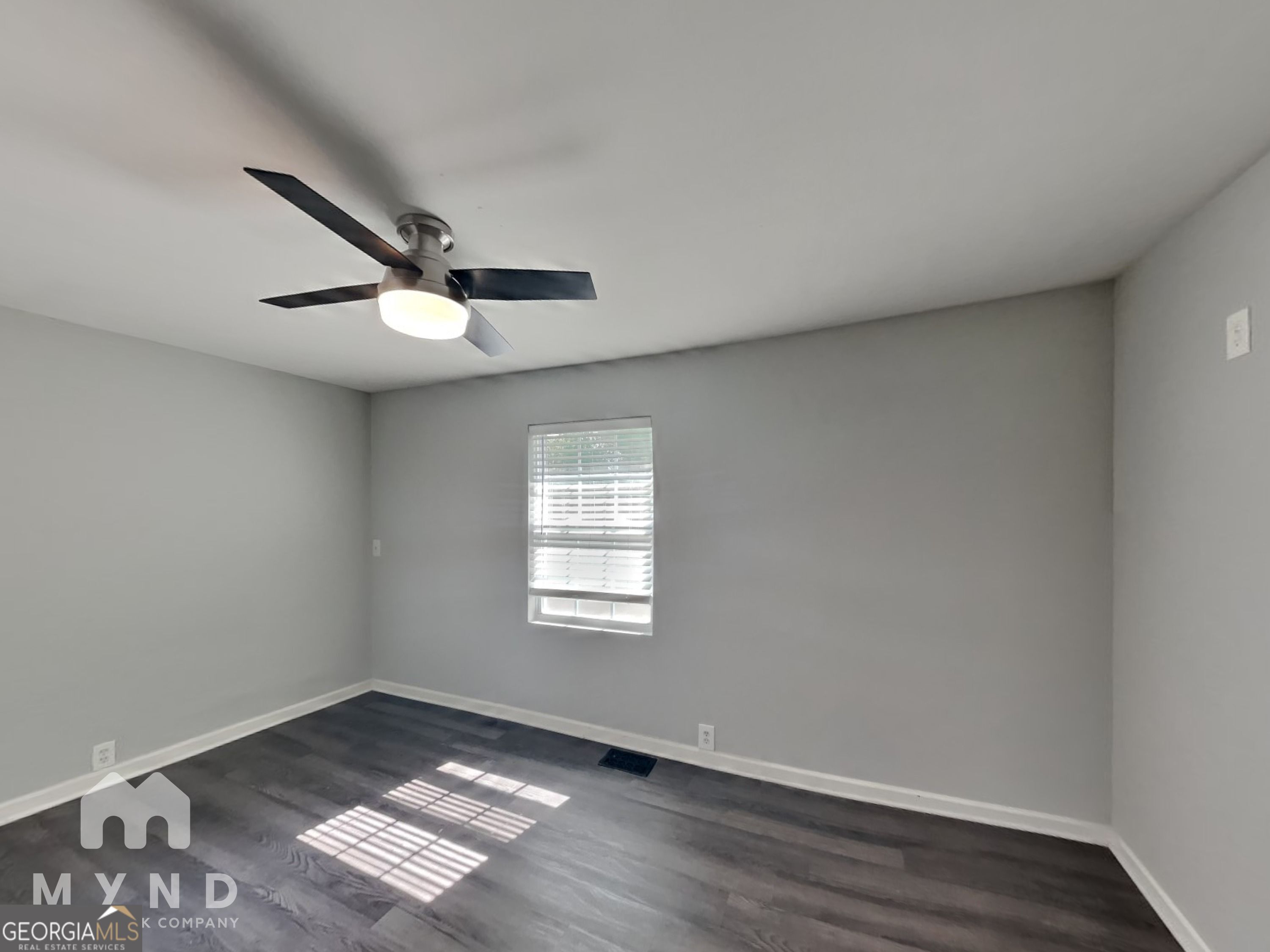 4202 Old Rock Cut Road Conley, GA 30288 - Photo 11 of 21 an empty room with wooden floor fan and windows