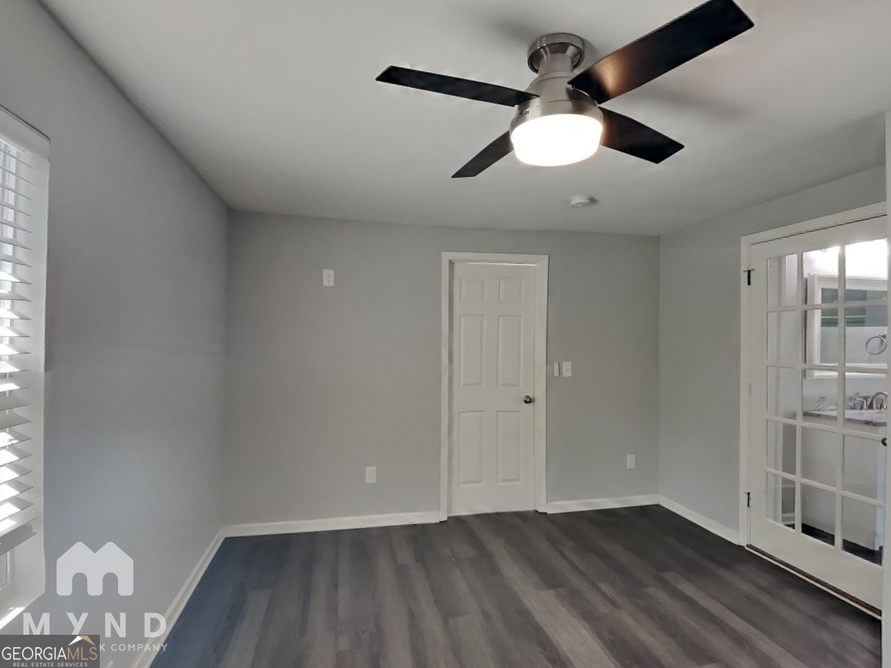 4202 Old Rock Cut Road Conley, GA 30288 - Photo 12 of 21 an empty room with wooden floor fan and windows
