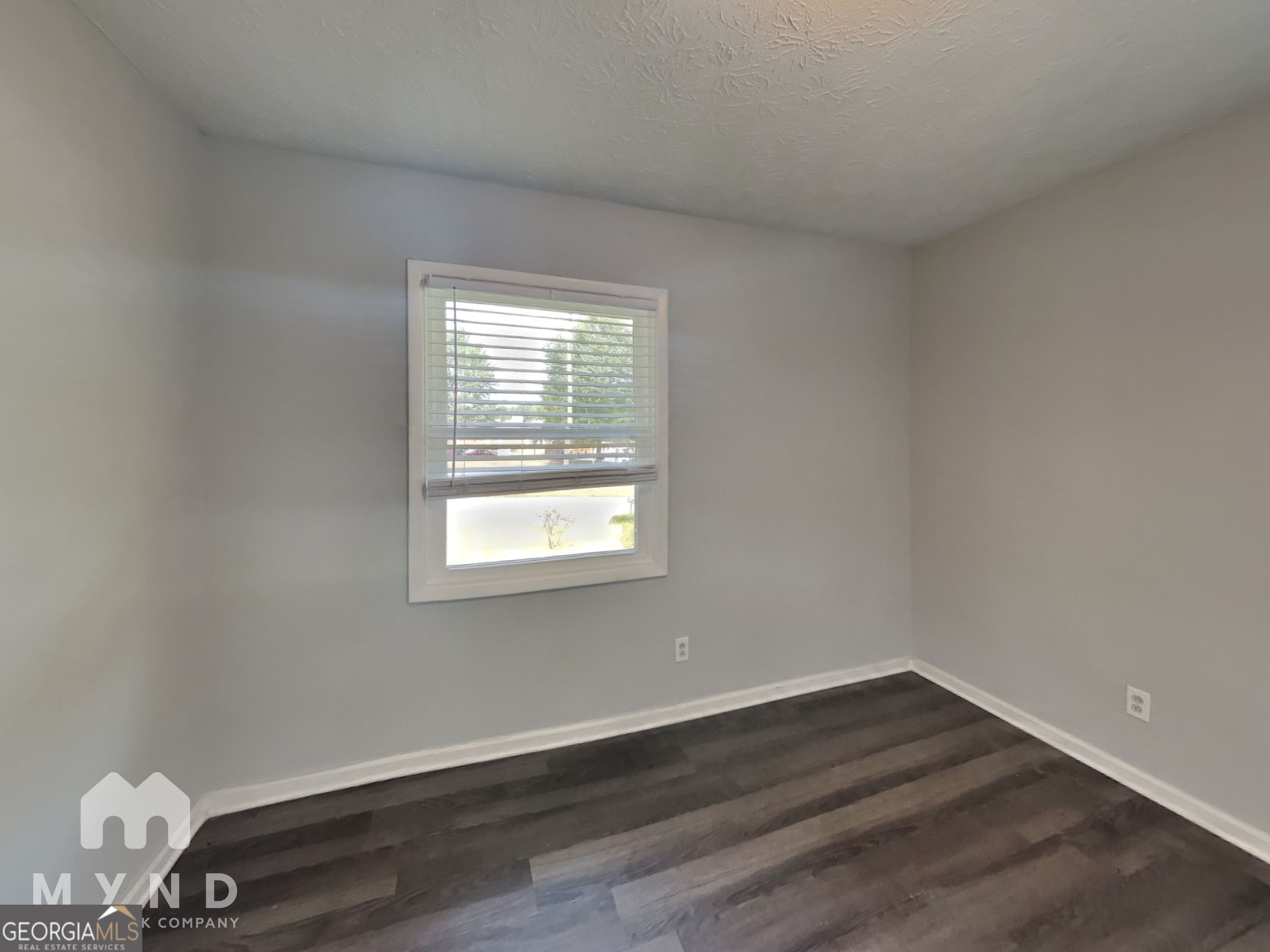 4202 Old Rock Cut Road Conley, GA 30288 - Photo 16 of 21 a view of an empty room with wooden floor and a window