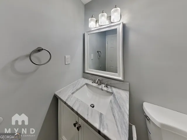 a bathroom with a sink vanity and a mirror