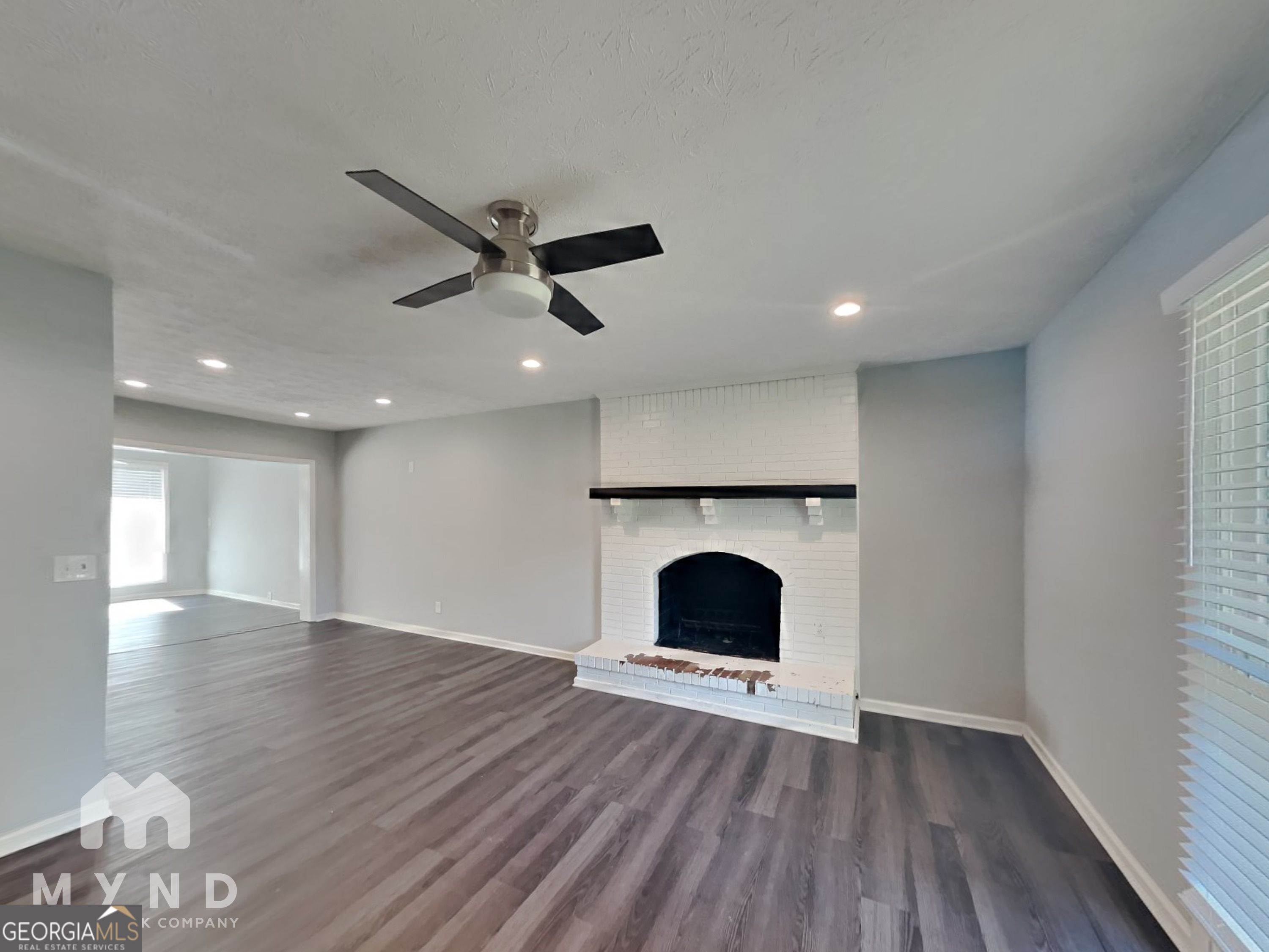 4202 Old Rock Cut Road Conley, GA 30288 - Photo 4 of 21 a view of an empty room with wooden floor and a window