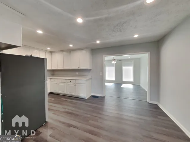 a view of a kitchen with a sink and cabinets