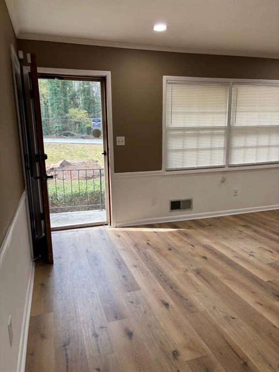 616 Fayetteville Road Jonesboro, GA 30236 - Photo 13 of 14 an empty room with wooden floor and windows