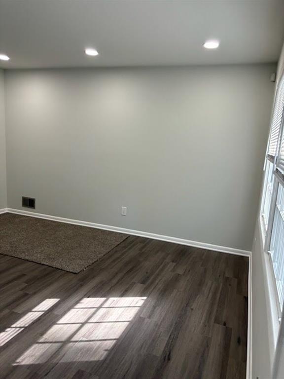 616 Fayetteville Road Jonesboro, GA 30236 - Photo 8 of 14 an empty room with wooden floor and windows