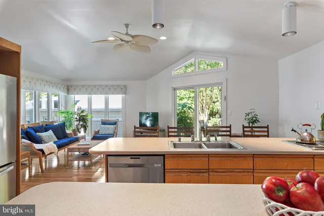 a kitchen with a sink and living room