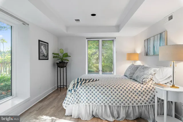 a bedroom with a bed and a potted plant