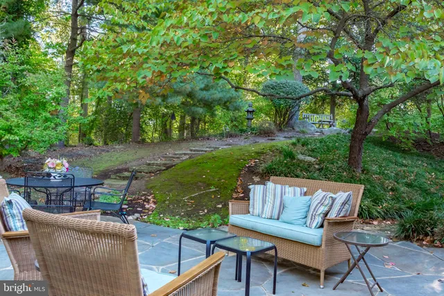 a view of a patio with couches table and chairs and potted plants